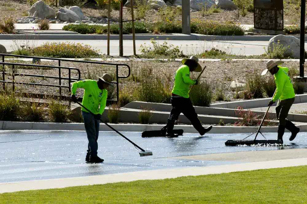 Commercial cleaning crew sweeping and polishing a finished construction site